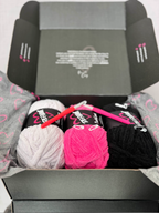 Yarn balls with a crochet hooks inside a branded Defiant box