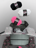 Yarn balls with 'Defiant' labels on a gray background