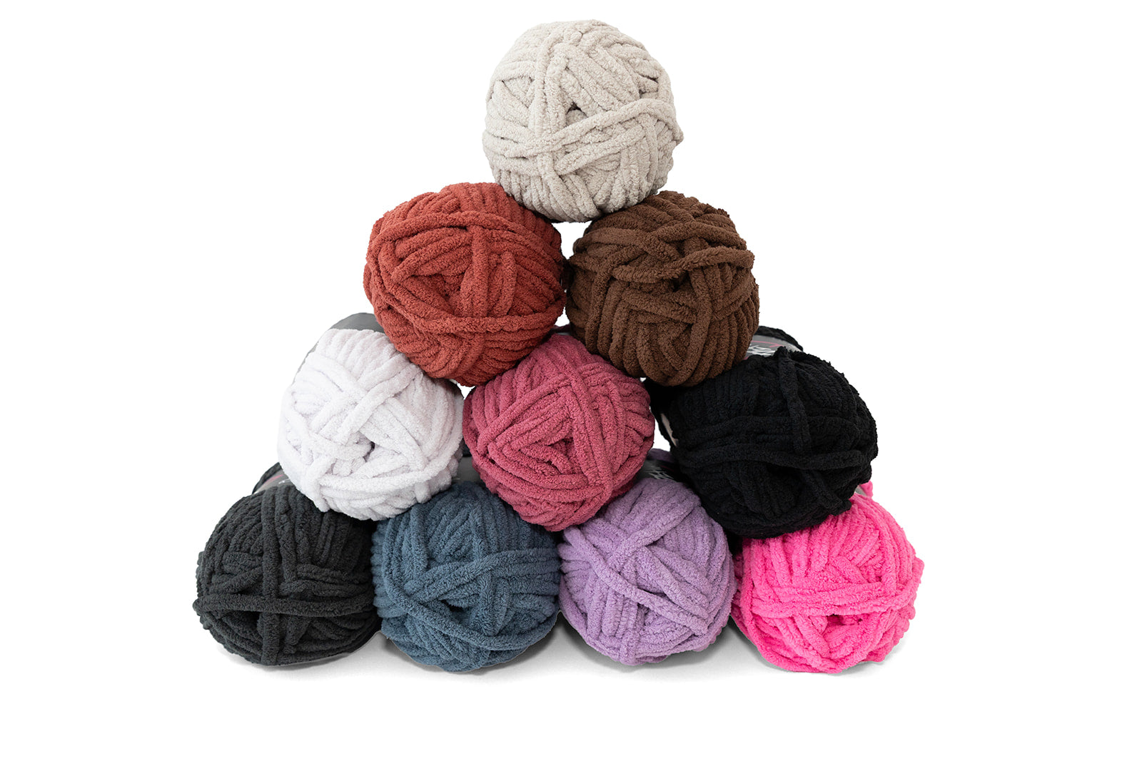 Assorted color yarn balls stacked on a white background