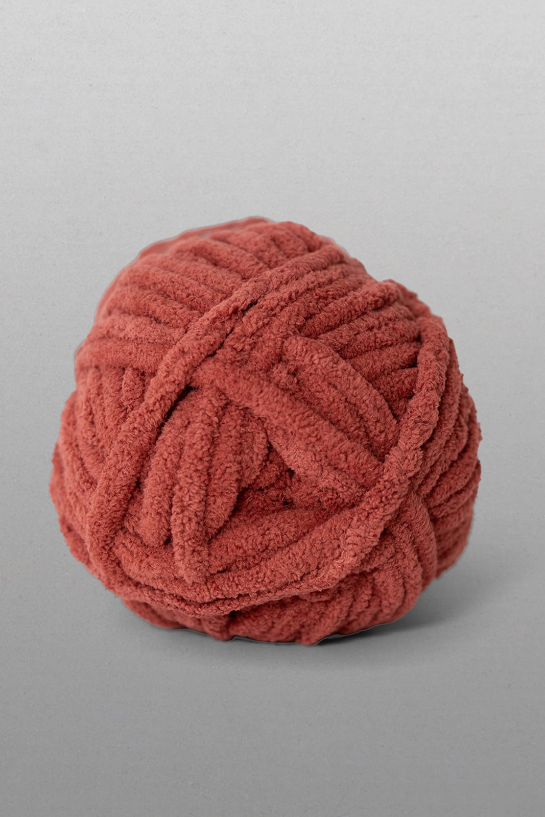 Red ball of yarn on a gray background