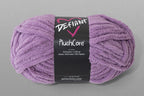 Purple skein of yarn with a Defiant label on a gray background