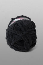 Black yarn ball on a gray background