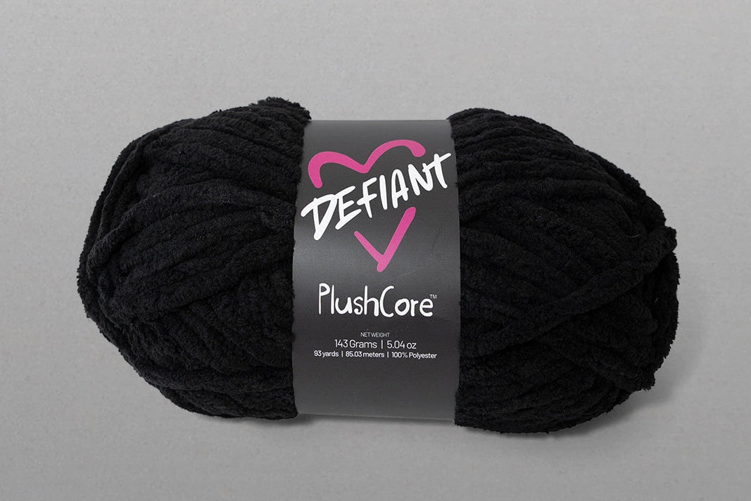Black skein of yarn with a Defiant label on a gray background