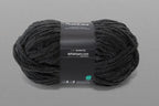 Black yarn ball with a label on a gray background