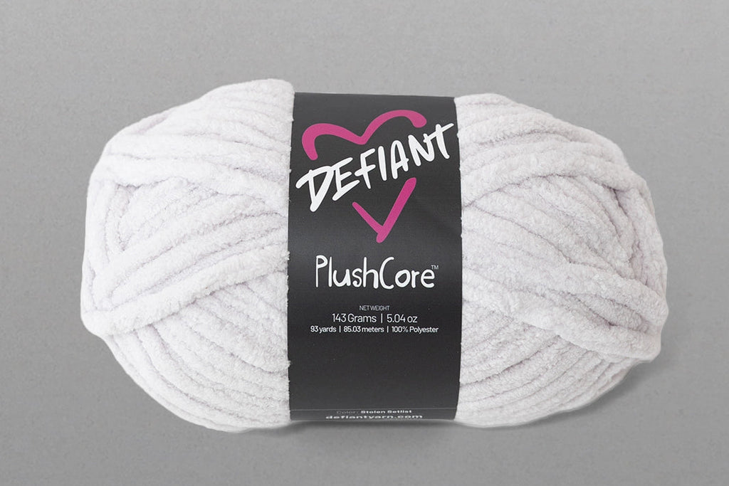 White skein of yarn with a Defiant label on a gray background