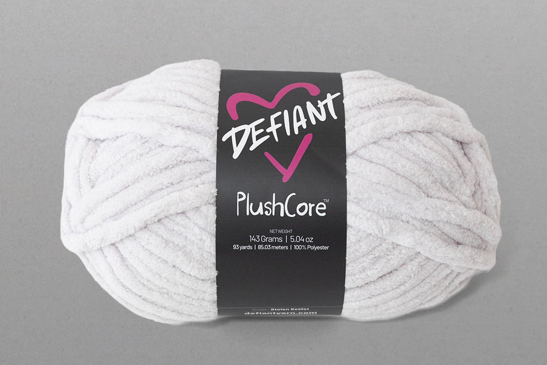 White skein of yarn with a Defiant label on a gray background