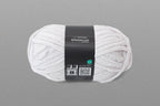 Ball of white yarn with a label on a gray background