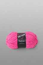 Pink skein of yarn with a black label on a gray background