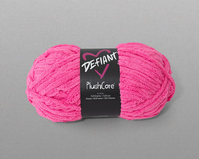 Pink skein of yarn with a black label on a gray background