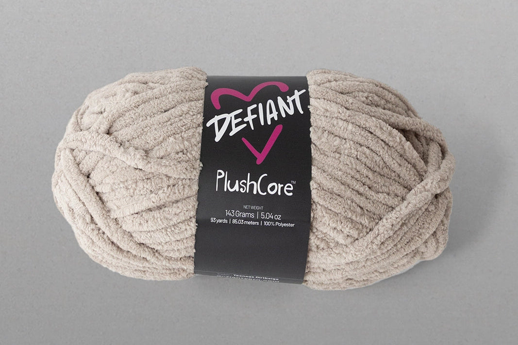 Ball of yarn with 'Defiant' label on a gray background