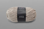 Ball of yarn with a label on a gray background
