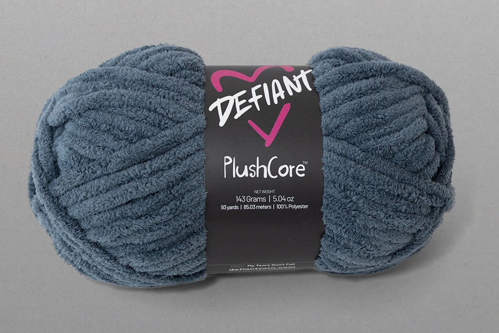Blue skein of yarn with a Defiant label on a gray background