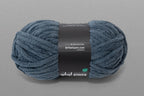 Blue skein of yarn with a label on a gray background