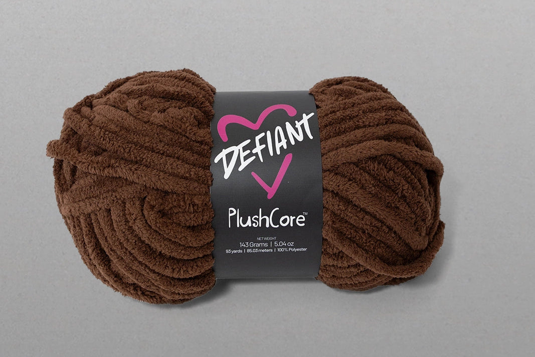 Brown skein of yarn with a Defiant label on a gray background