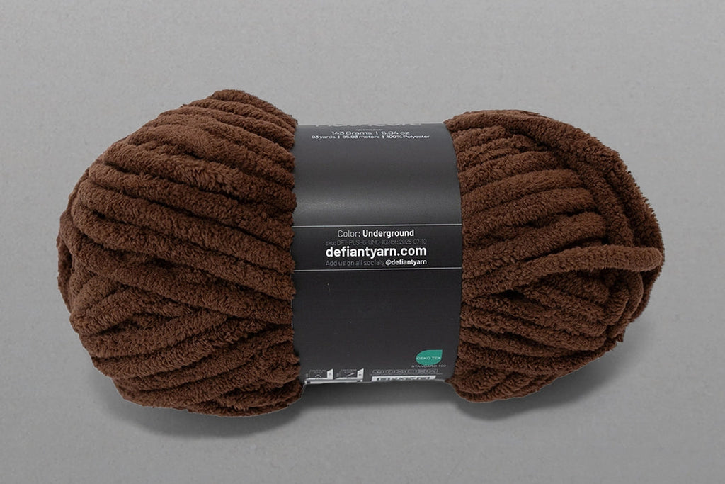 Brown skein of yarn with a label on a gray background